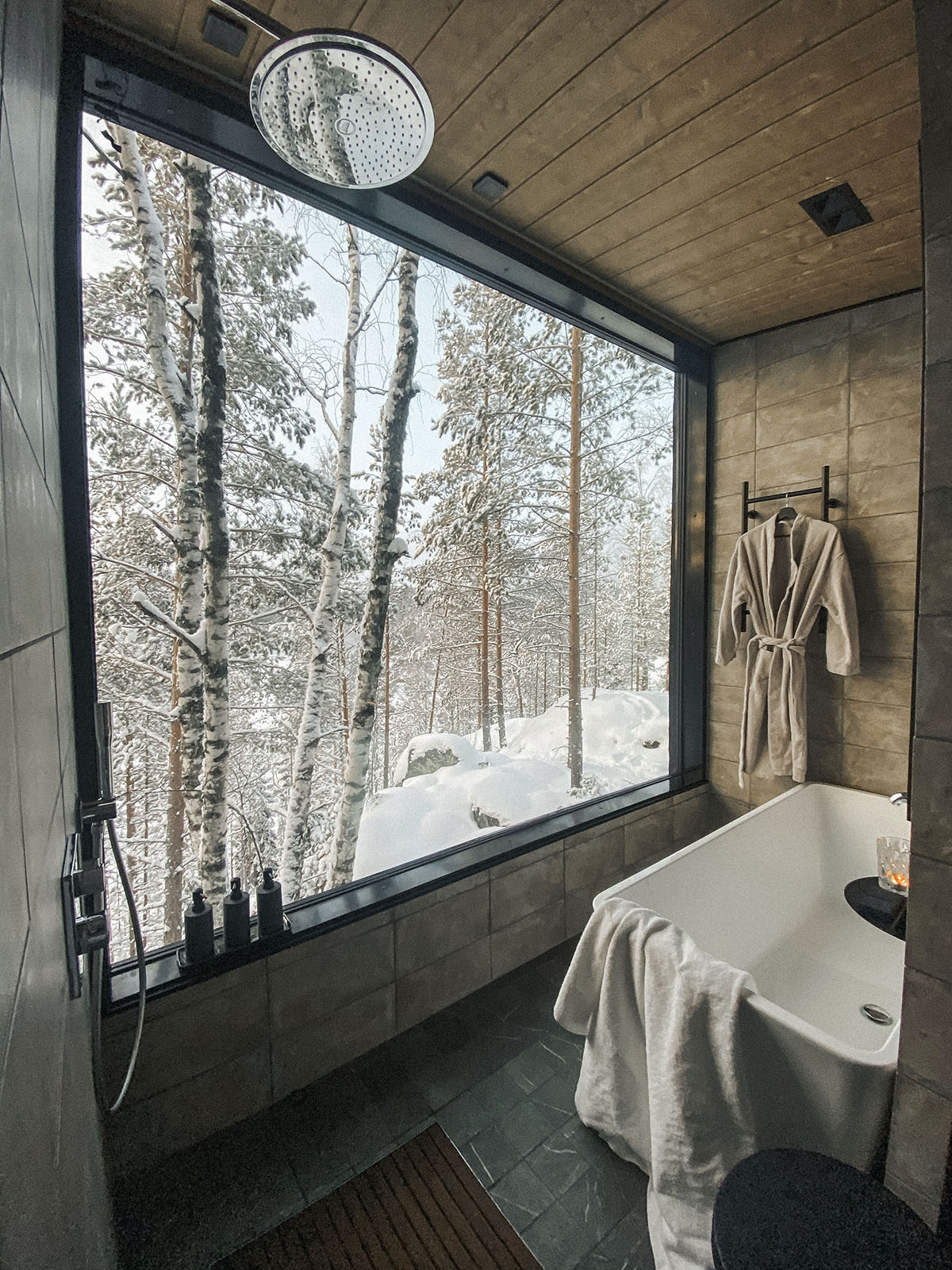 View of a bathroom with a huge window in the luxury resort Kuru.