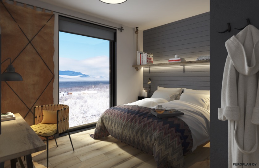 Modern hotel room with a double bed and a floor to ceiling window showing a wintery landscape.